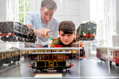 boy-enjoying-train-exhibition-casino-model-railway Boy and Adult enjoying train exhibition at casino model railway