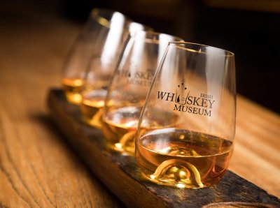 Sampling whiskey at the Irish Whiskey Museum Four whiskey glasses with whiskey at irish whiskey museum